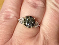 Moissanite ring. A 3ct certified GRAY Moissanite with 1.5cttw of heart-cut white zircons, set in a sterling silver basket 3-stone design!