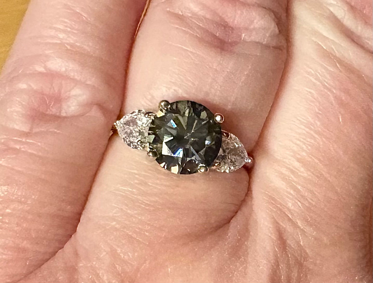 Moissanite ring. A 3ct certified GRAY Moissanite with 1.5cttw of heart-cut white zircons, set in a sterling silver basket 3-stone design!