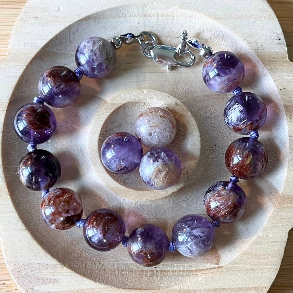 Super seven amethyst bracelet. AAA-grade 12mm “super seven”, mineral name cacoxenite amethyst, hand-knotted with silvery or golden hardware!
