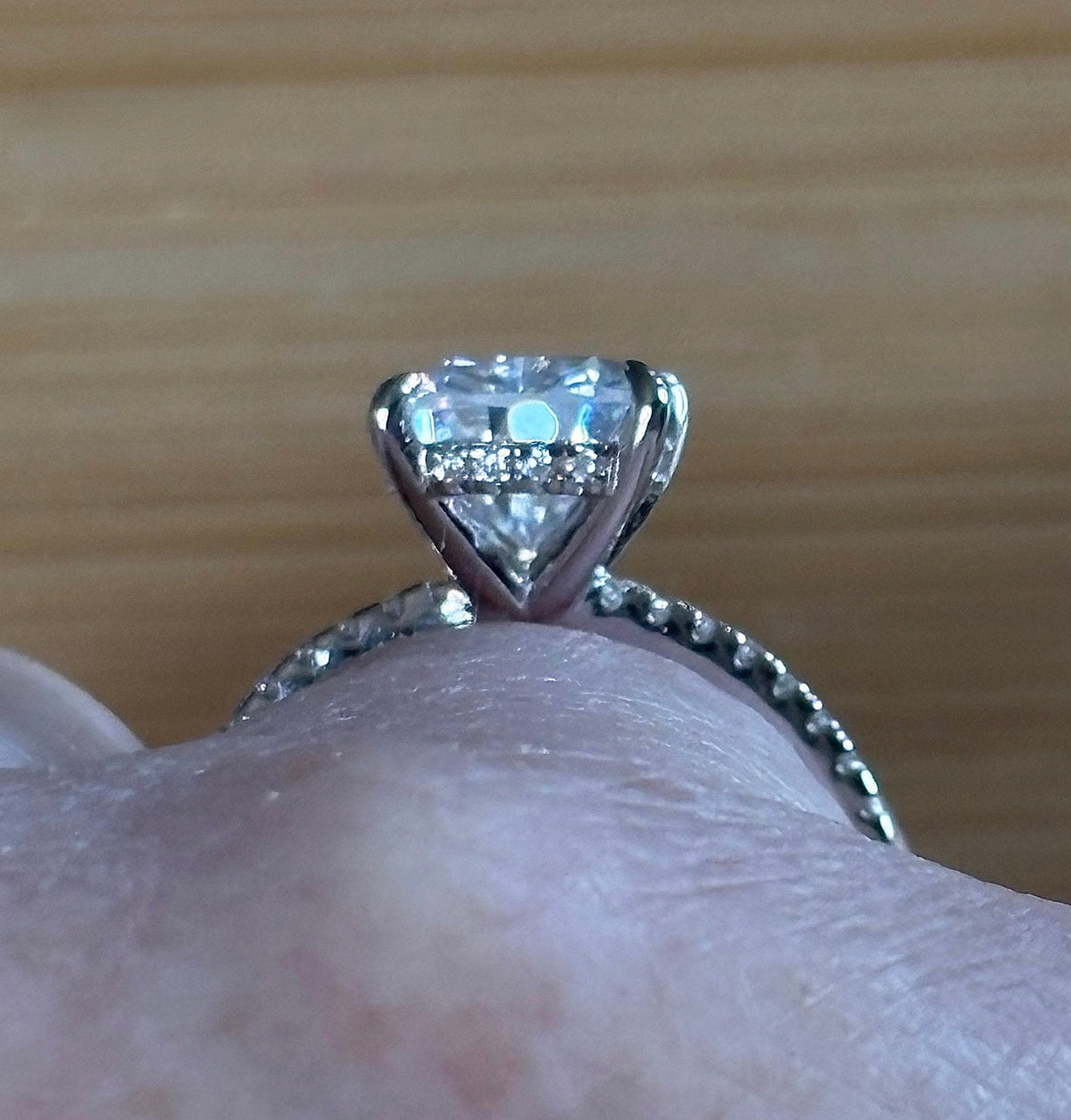 A certified 5ct pear-cut Moissanite solitaire in 925 sterling OR 935 Argentium silver with 18k, with pavé-set Moissanite shoulders and Moissanite hidden halo!