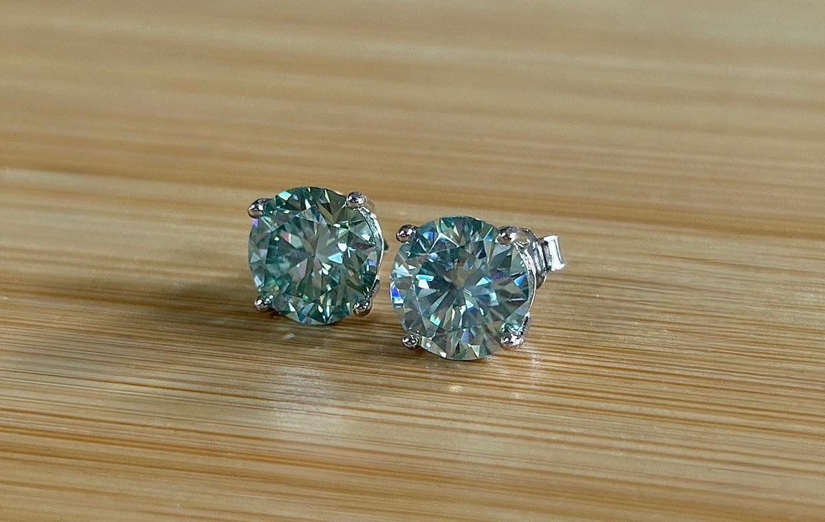 Moissanite earrings. A 6ctw certified pair of true icy baby blue Moissanite studs in sterling silver baskets with gleaming white rhodium!