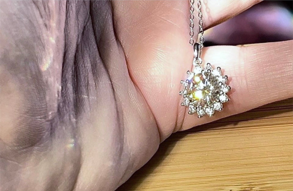 Moissanite necklace. A 1ct or 3ct Moissanite in a halo of sparkling white zircons (I call it the “Sunflower” pendant)! In sterling silver and 18k!