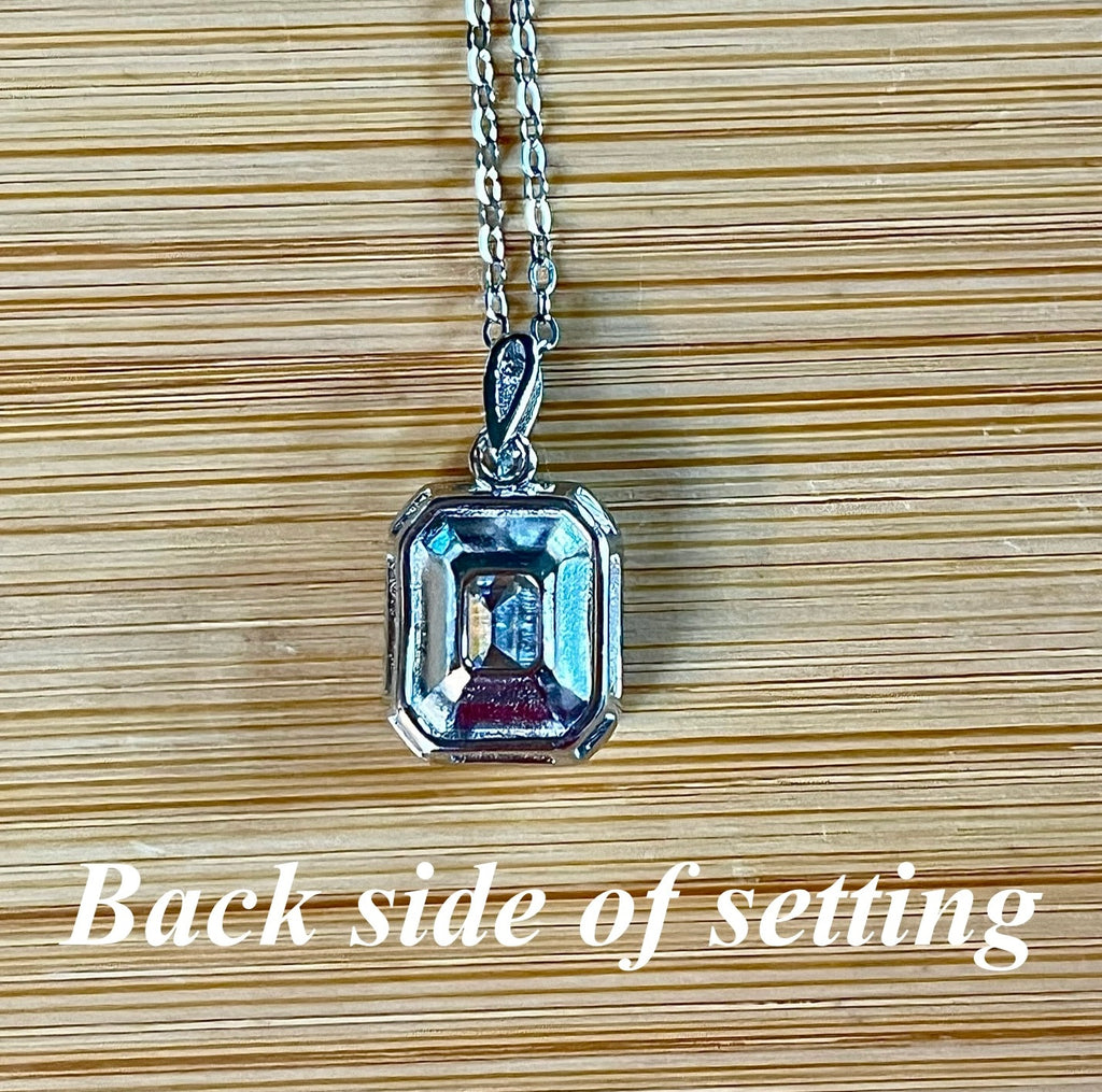 Moissanite necklace. An elegant 3ct certified emerald-cut Moissanite within a halo of shining white zircons, in 18k gold-embraced sterling!