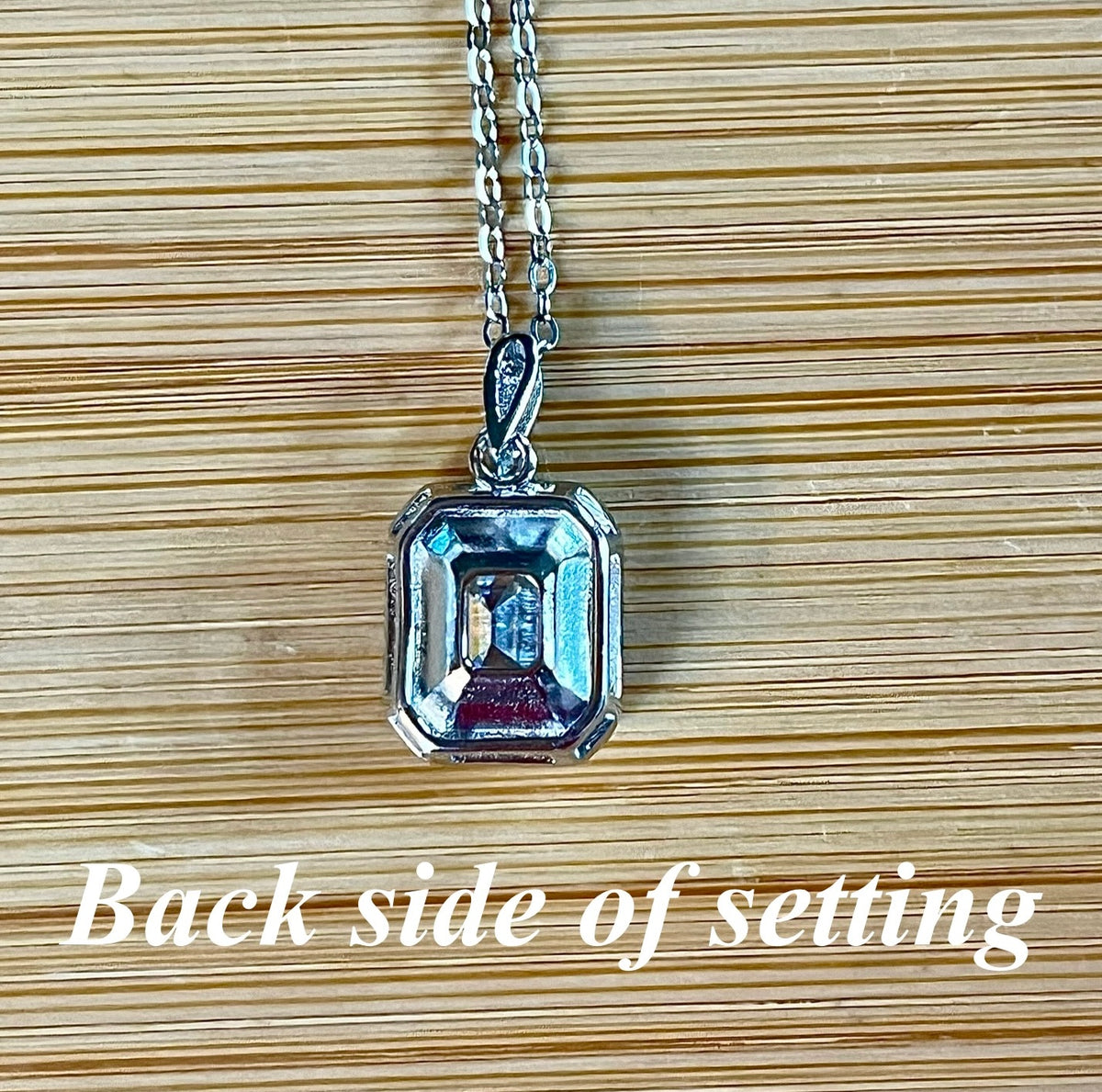 Moissanite necklace. An elegant 3ct certified emerald-cut Moissanite within a halo of shining white zircons, in 18k gold-embraced sterling!