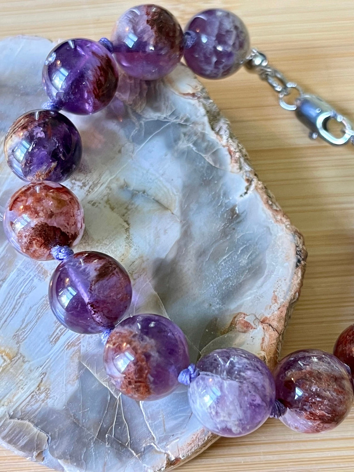 Super seven amethyst bracelet. AAA-grade 12mm “super seven”, mineral name cacoxenite amethyst, hand-knotted with silvery or golden hardware!