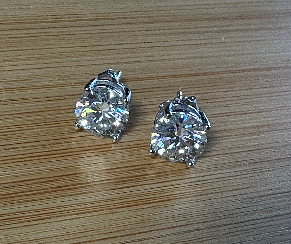 Moissanite earrings. A delicate certified 2cttw pair of 3-prong or 4-prong round brilliant Moissanites in 18k gold-embraced sterling silver baskets! Classic!