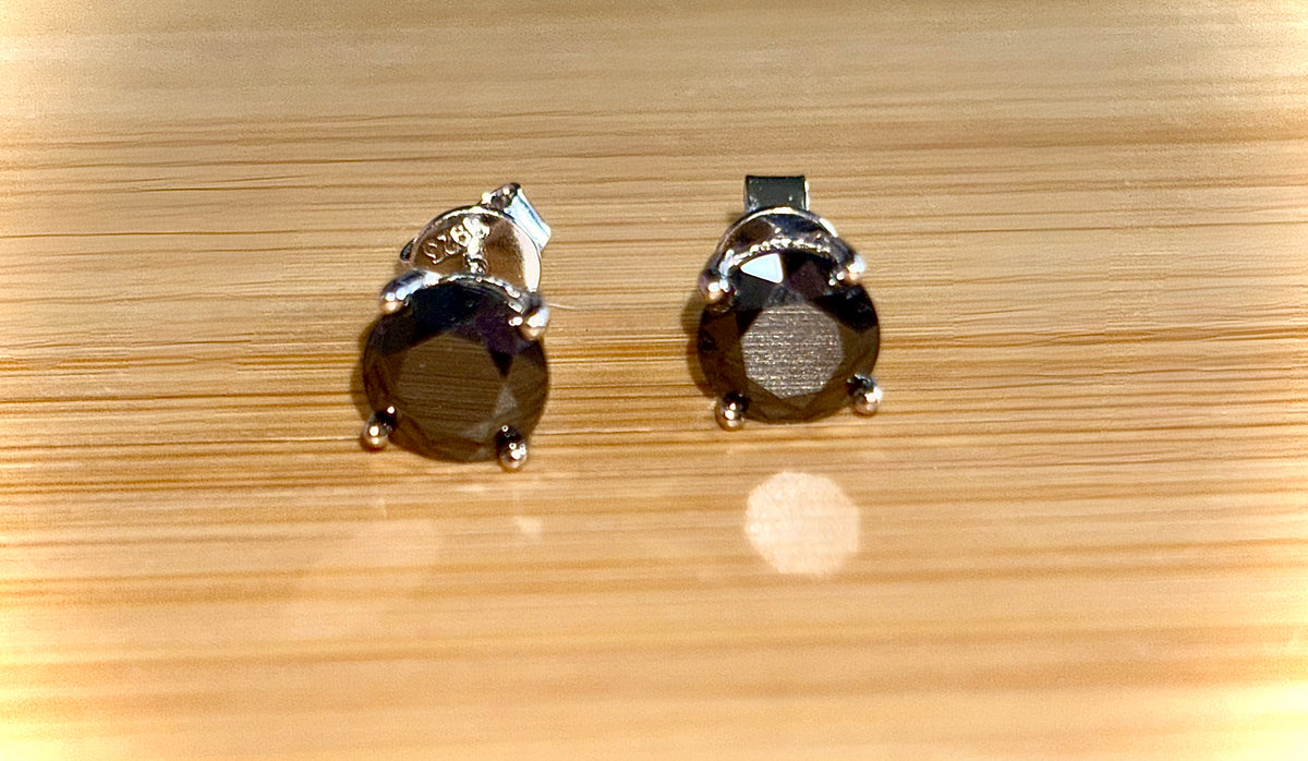 Moissanite studs. A 2cttw certified pair of black Moissanite studs in a sterling silver basket setting with 18k white gold plating!