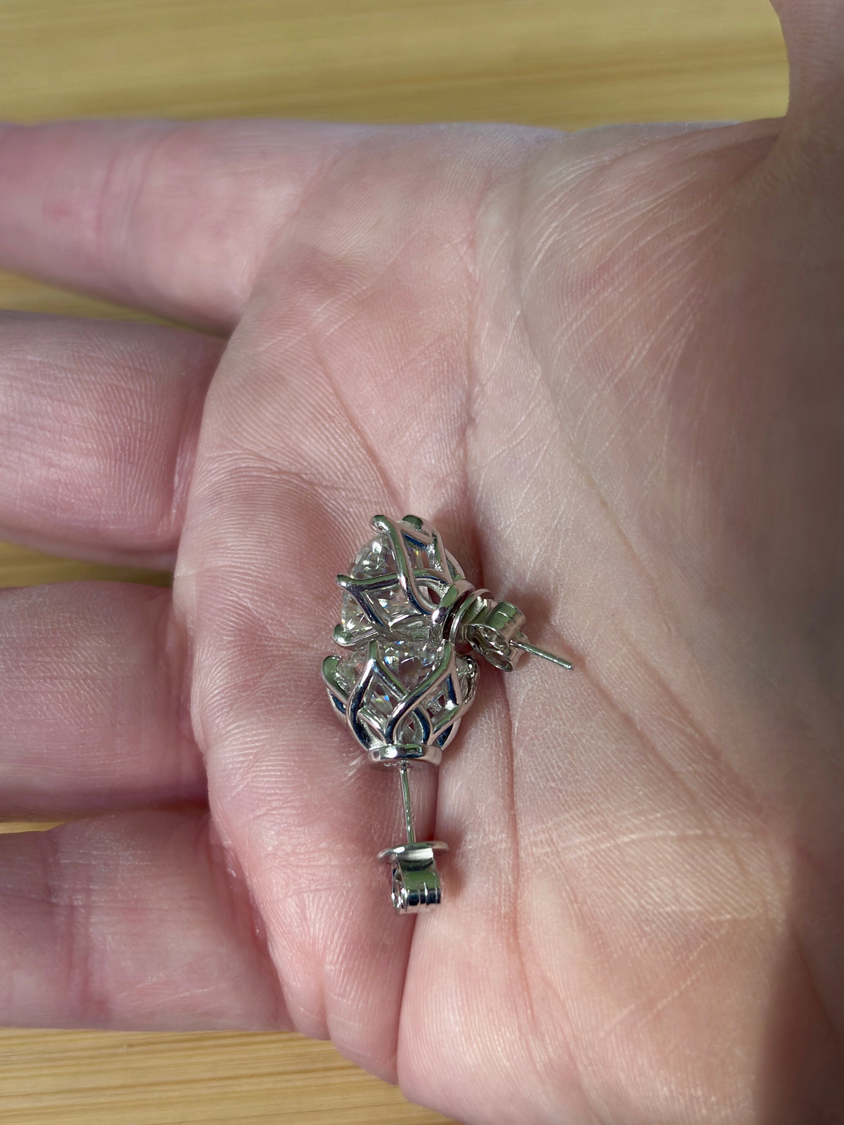 A 10ctw pair of double certified Moissanite studs in lotus-shaped sterling silver baskets!