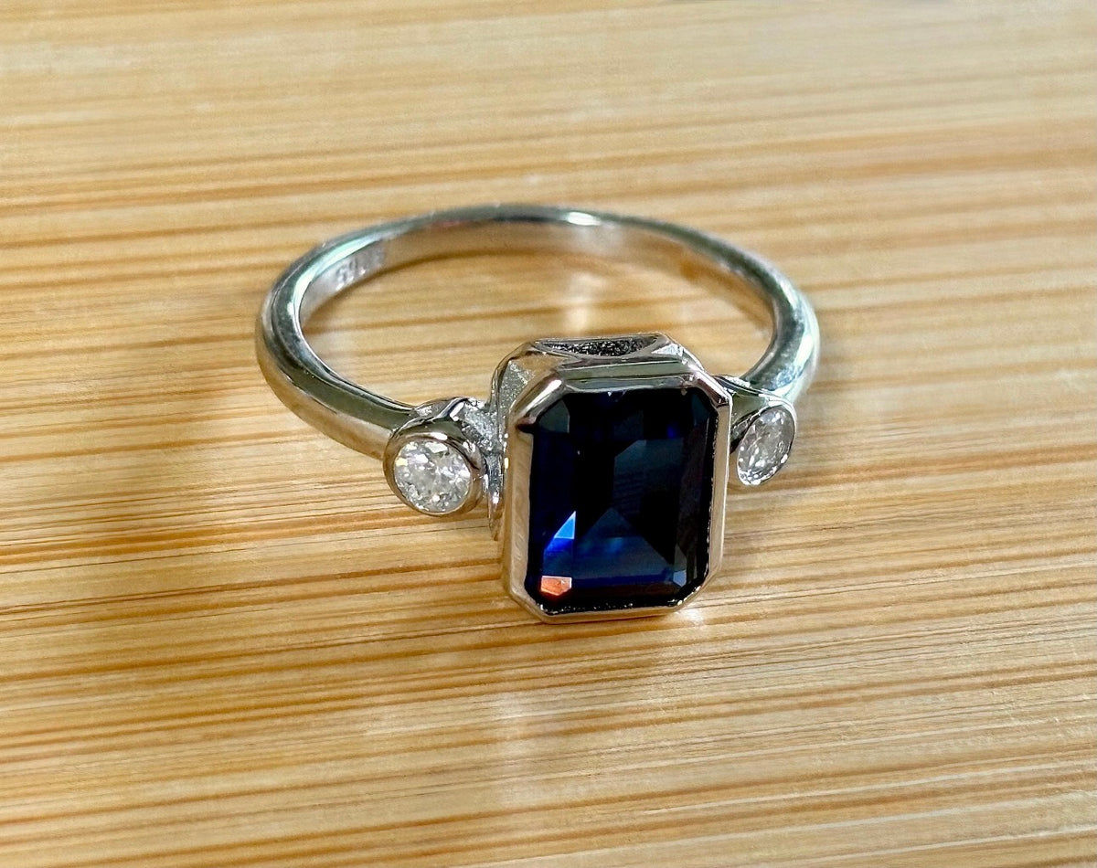 Blue sapphire and Moissanite ring. A certified 3ct lab-grown emerald-cut sapphire and .20ctw Moissanite ring in 925 sterling OR 935 Argentium!