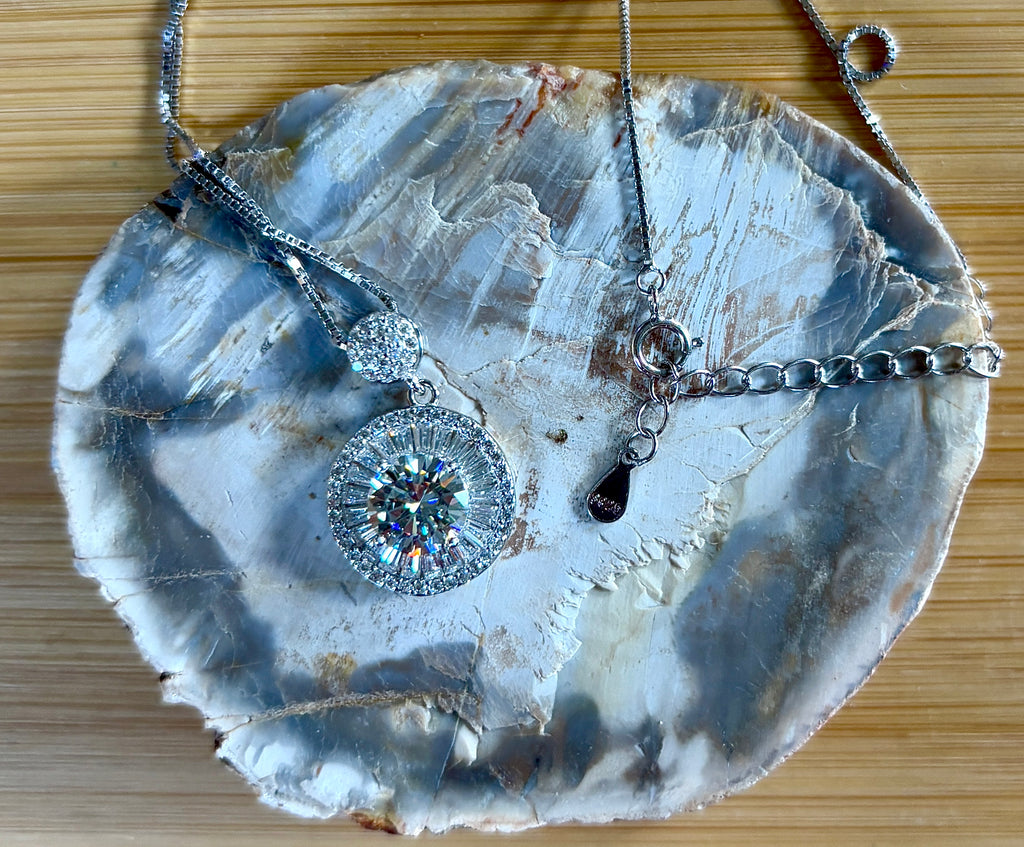 Moissanite necklace. The certified 2ct Moissanite “Sunburst” necklace with a 61 gemstone pendant plus more in the bail! Radiantly beautiful!