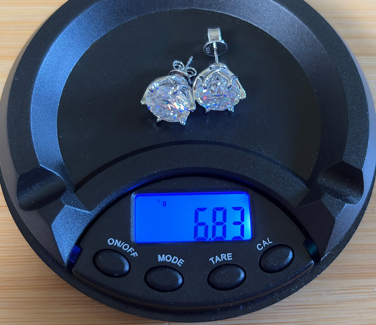 A 10ctw pair of double certified Moissanite studs in lotus-shaped sterling silver baskets!