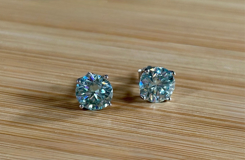 Moissanite earrings. A 6ctw certified pair of true icy baby blue Moissanite studs in sterling silver baskets with gleaming white rhodium!