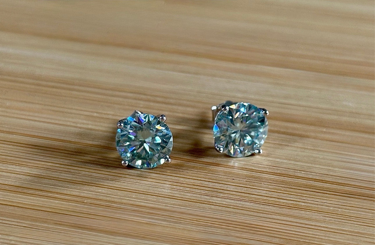 Moissanite earrings. A 6ctw certified pair of true icy baby blue Moissanite studs in sterling silver baskets with gleaming white rhodium!