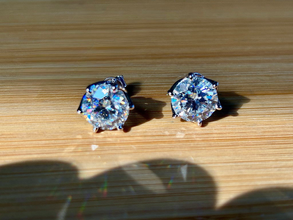 A 10ctw pair of double certified Moissanite studs in lotus-shaped sterling silver baskets!