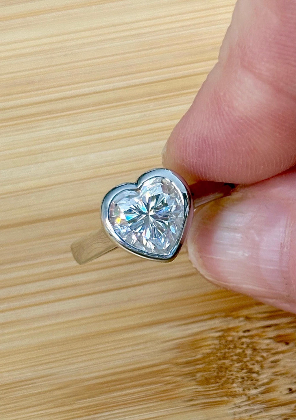 Moissanite ring. A high-end solitaire with a certified 3ct heart-cut stone, bezel-set in a heavy sterling silver mounting and bathed in 18k!