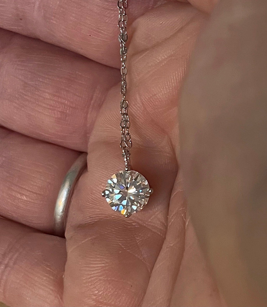 2ct Moissanite solitaire necklace. A 2ct “Floating Moissanite” in sterling silver creates the illusion of being suspended by nothing more than spider silk!