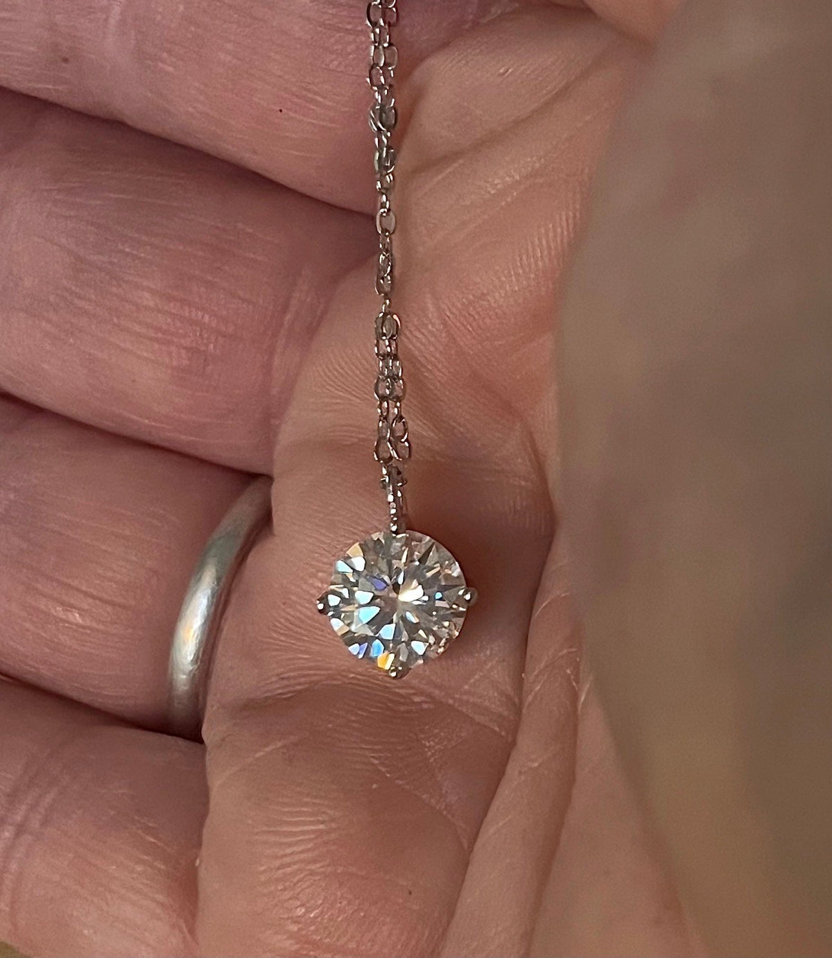 2ct Moissanite solitaire necklace. A 2ct “Floating Moissanite” in sterling silver creates the illusion of being suspended by nothing more than spider silk!