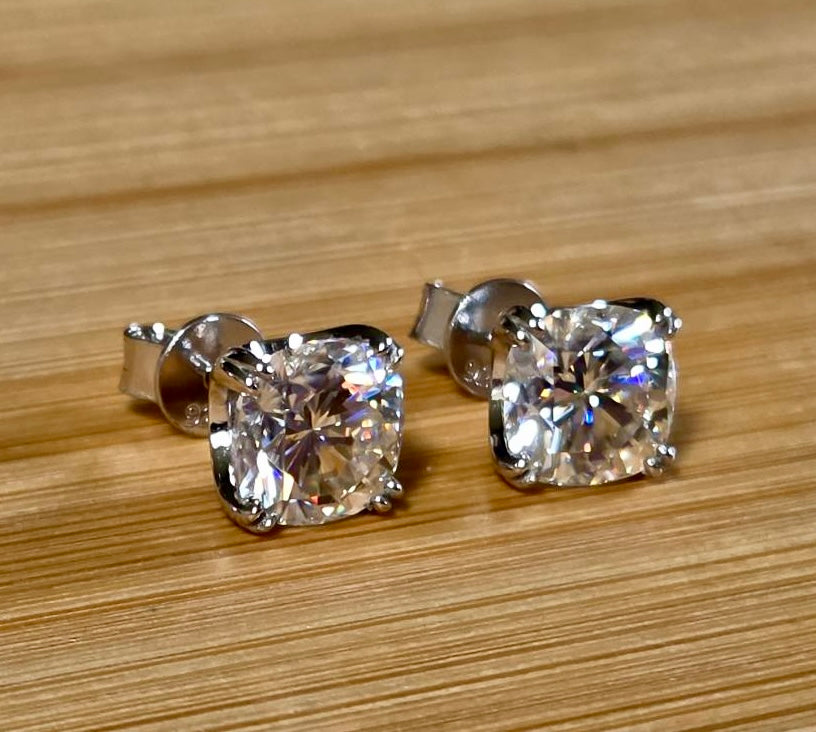 6ctw cushion-cut Moissanite studs in elegant sterling silver double-claw mountings! With brilliant faceting, these earrings are showstoppers!
