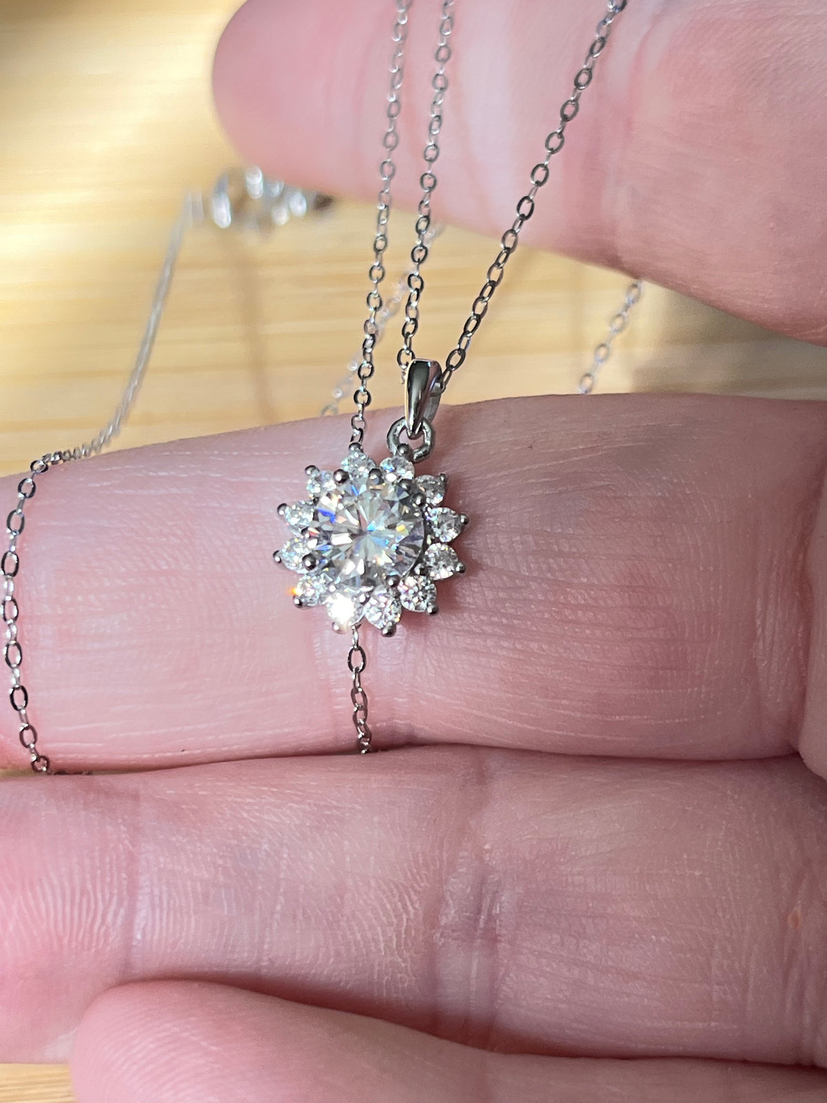 Moissanite necklace. A 1ct or 3ct Moissanite in a halo of sparkling white zircons (I call it the “Sunflower” pendant)! In sterling silver and 18k!