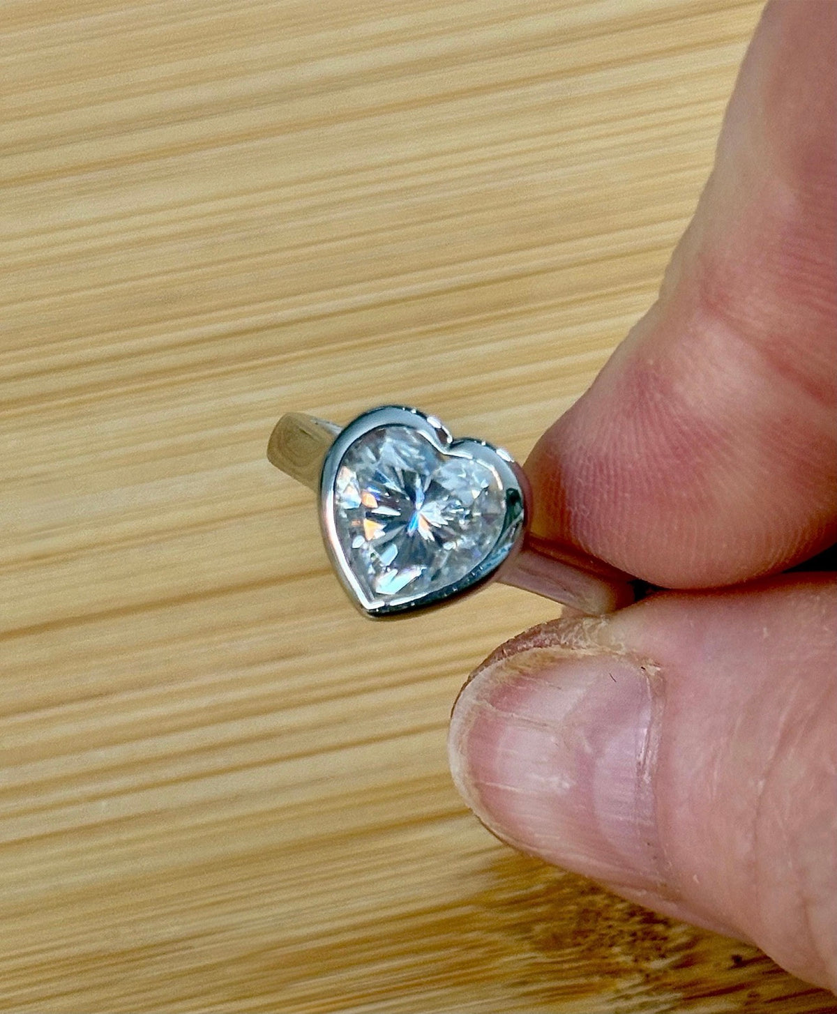 Moissanite ring. A high-end solitaire with a certified 3ct heart-cut stone, bezel-set in a heavy sterling silver mounting and bathed in 18k!
