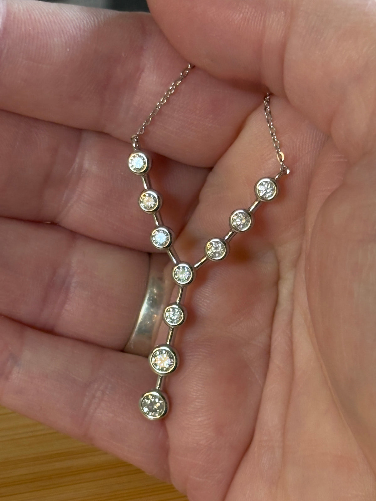 Moissanite neckpiece. A beautiful certified 1.4cttw Moissanite necklace featuring 10 round brilliants in a solid sterling bezel setting!