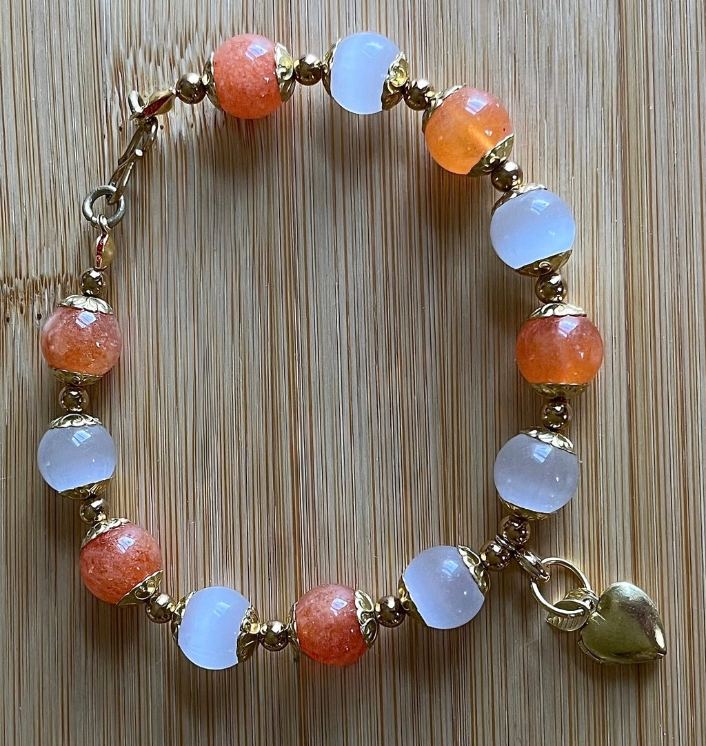 White selenite and tangerine chalcedony bracelet with raw brass and stainless steel components. The functioning brass locket is included!