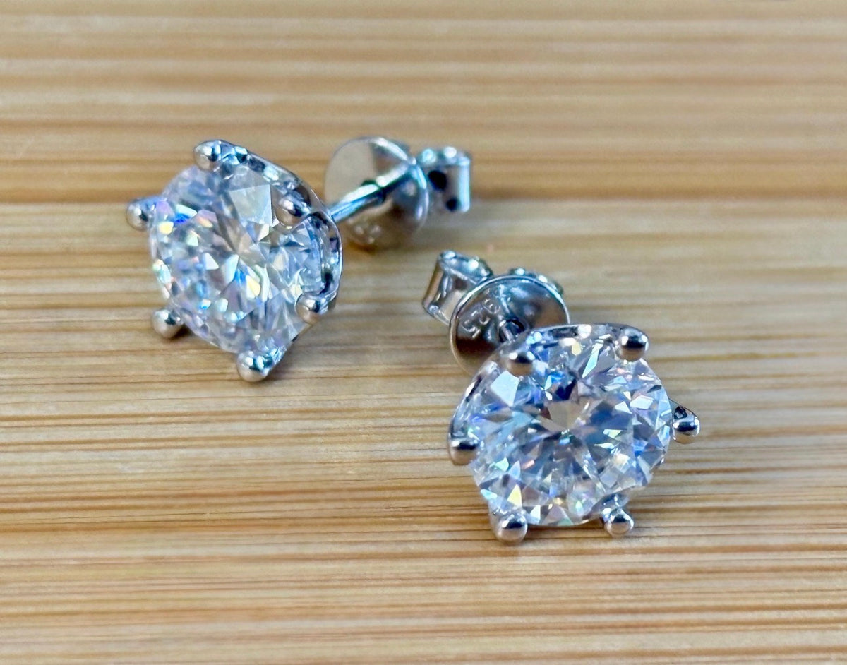 A certified pair of pretty, floral-inspired 2cttw or 4cttw Moissanite studs in poinsettia-shaped settings w/screwball backs OR 4cttw w/push backs!