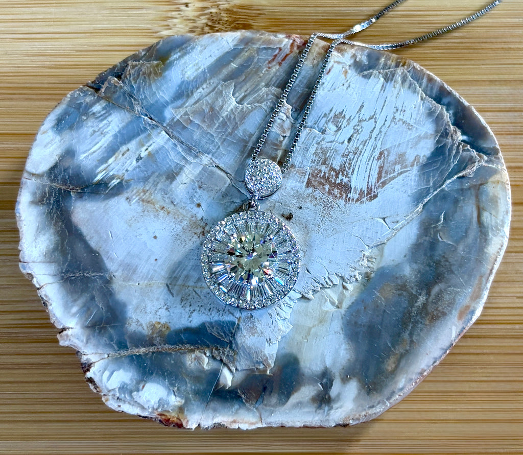 Moissanite necklace. The certified 2ct Moissanite “Sunburst” necklace with a 61 gemstone pendant plus more in the bail! Radiantly beautiful!