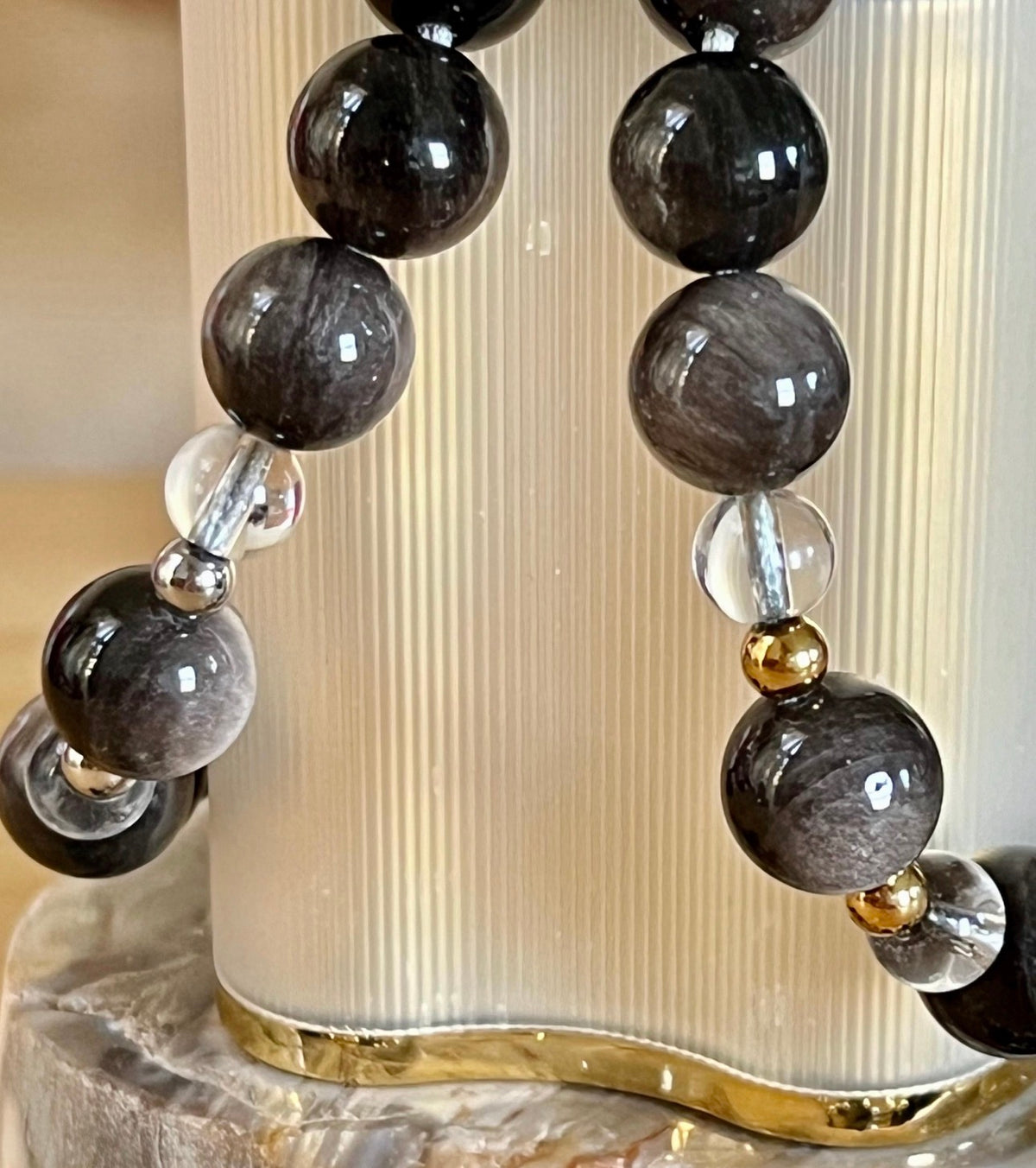 Silver sheen obsidian and clear quartz bracelet and earrings. Pair the “Silver Bells” bracelet and/or earrings with your little black party dress and be the Belle of the Ball!