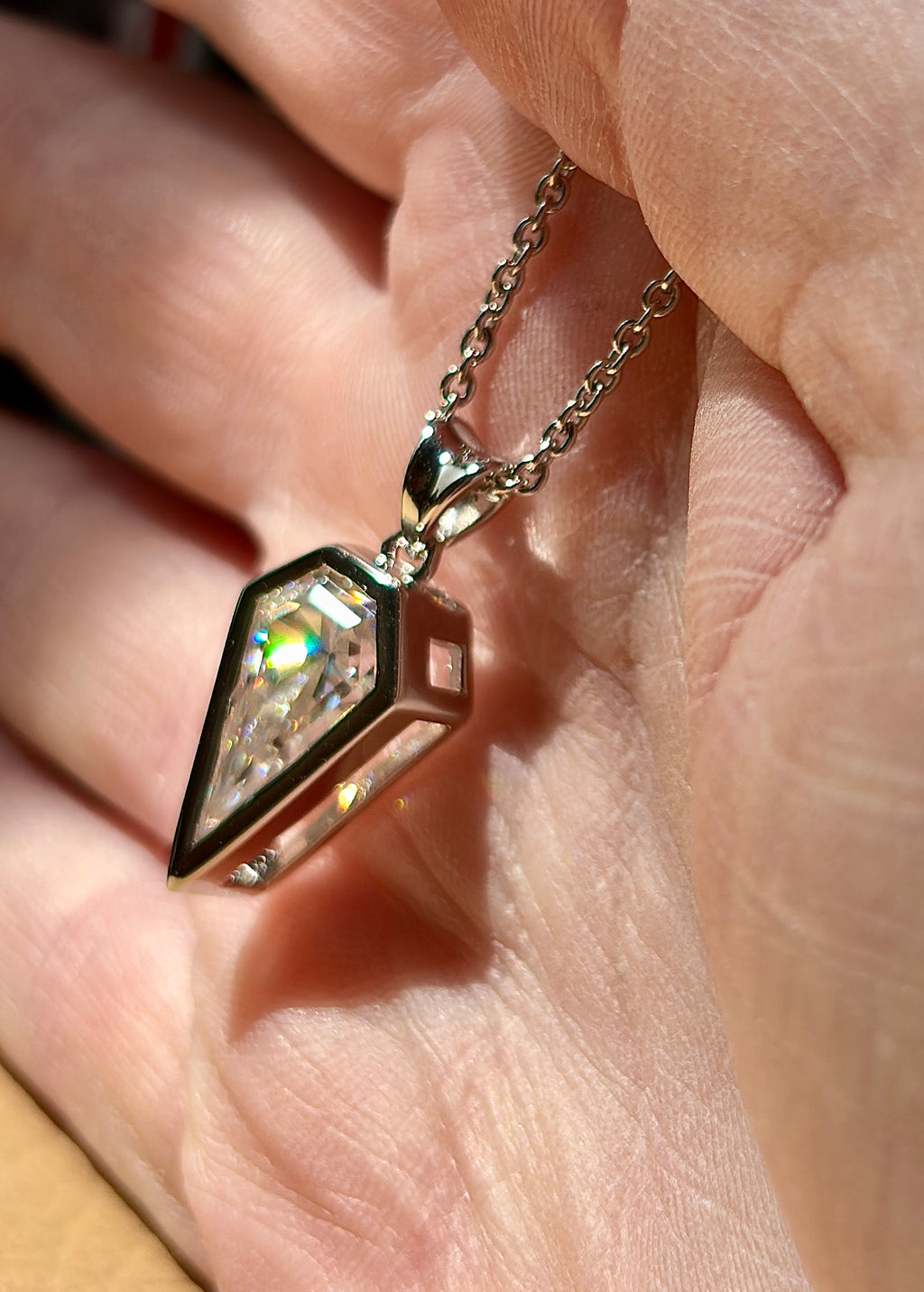 Moissanite necklace. “Flight!”, a kite-shaped, custom-cut 5ct Moissanite pendant! Hand-faceted by a master stone cutter and set in Argentium silver, it is suspended on a 20” sterling silver chain and is exclusive to Hand Knotted Jewelry!