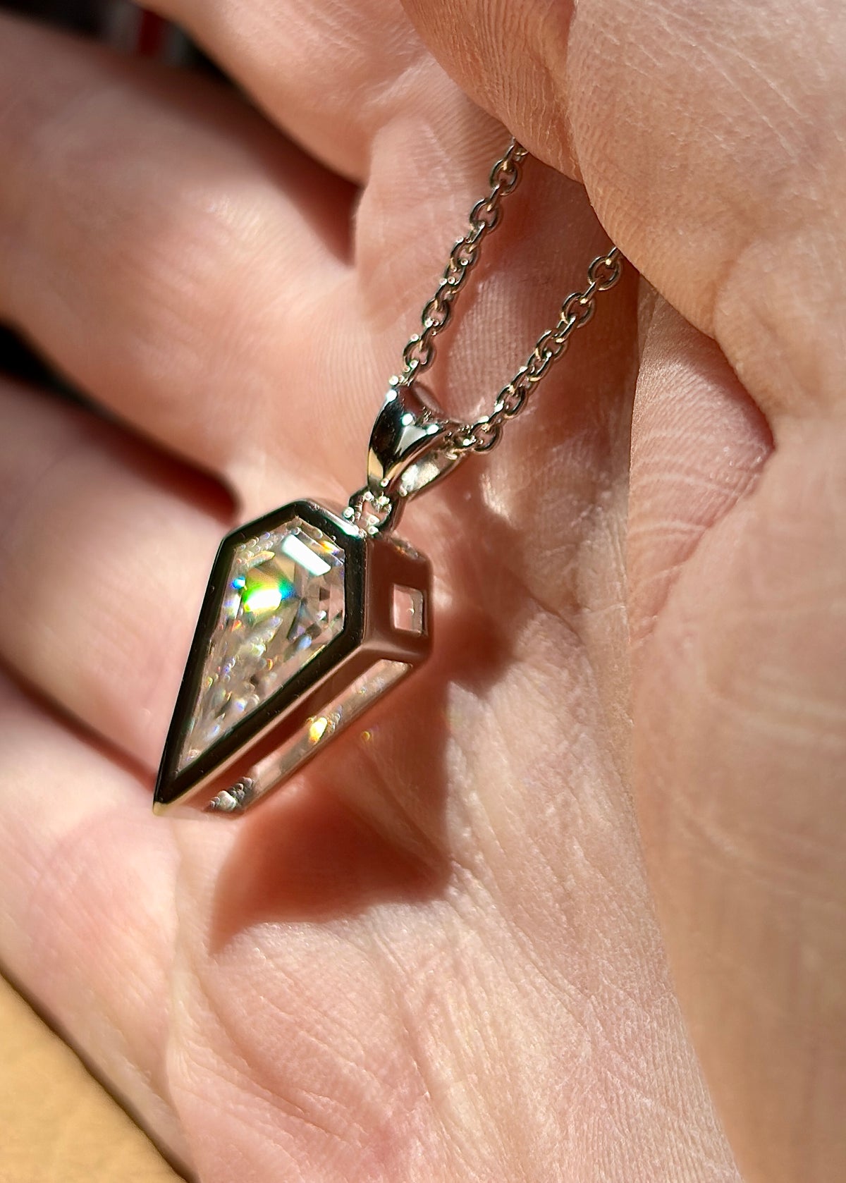Moissanite necklace. “Flight!”, a kite-shaped, custom-cut 5ct Moissanite pendant! Hand-faceted by a master stone cutter and set in Argentium silver, it is suspended on a 20” sterling silver chain and is exclusive to Hand Knotted Jewelry!