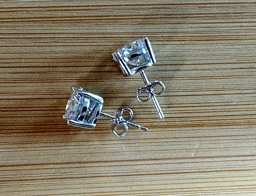 Moissanite earrings. A delicate certified 2cttw pair of 3-prong or 4-prong round brilliant Moissanites in 18k gold-embraced sterling silver baskets! Classic!