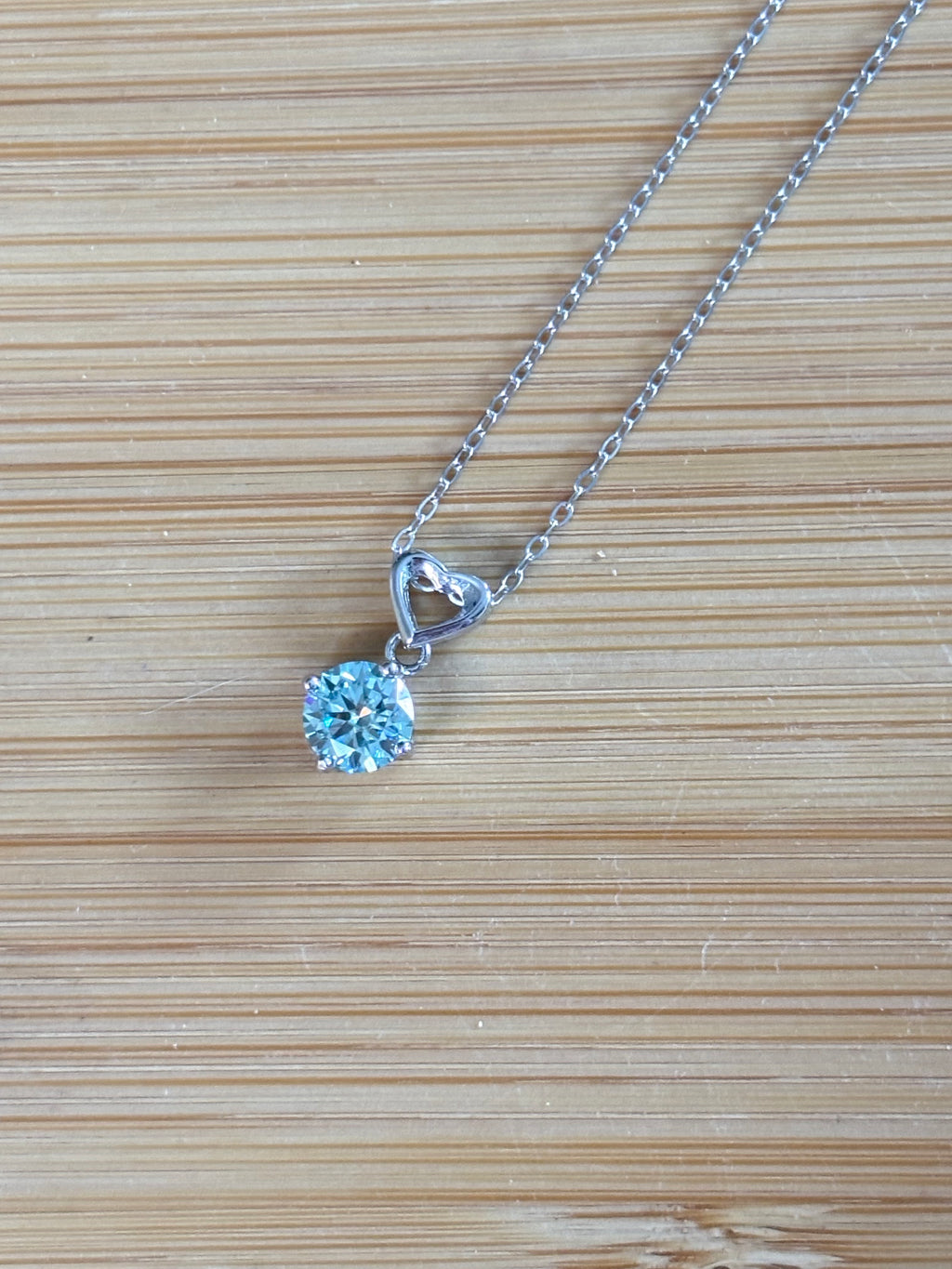 Moissanite necklace. A romantic heart-shaped pendant featuring a certified 1ct round WHITE or BLUE round brilliant Moissanite in sterling silver!