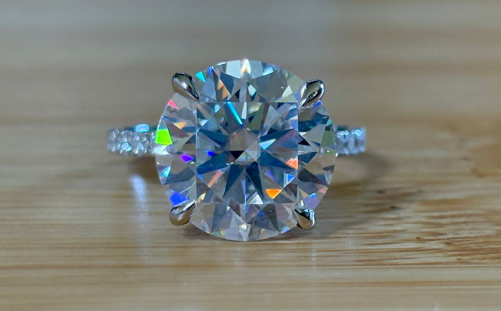 Moissanite solitaire. A glorious 10ct 8H8A Moissanite in a 4-prong mounting with a Moissanite “hidden halo” and shoulders, an 11.3cttw ring!