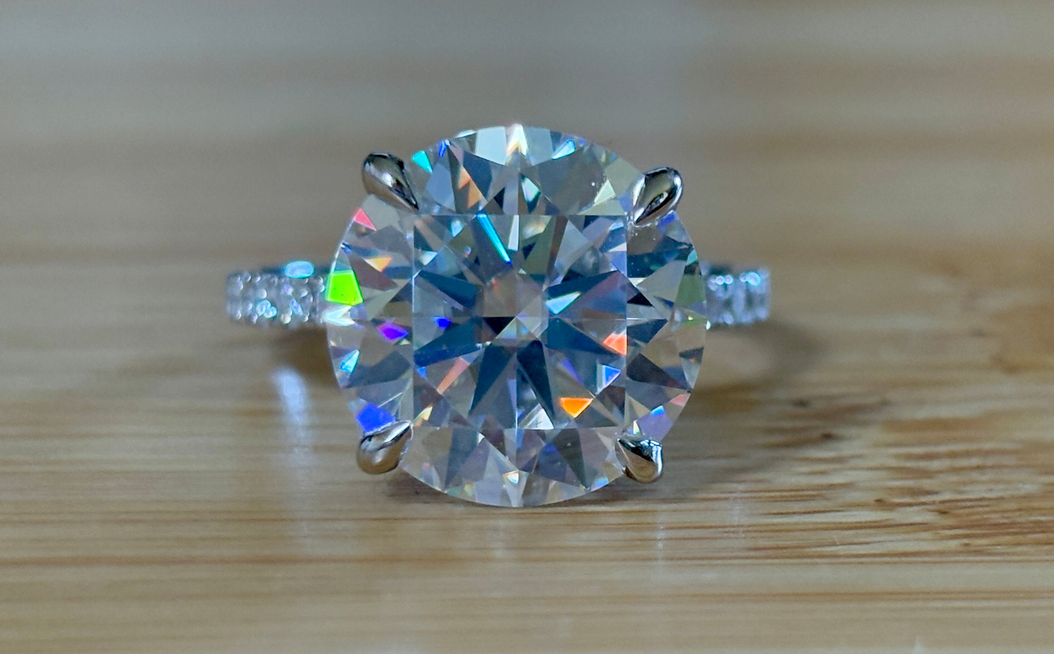 Moissanite solitaire. A glorious 10ct 8H8A Moissanite in a 4-prong mounting with a Moissanite “hidden halo” and shoulders, an 11.3cttw ring!