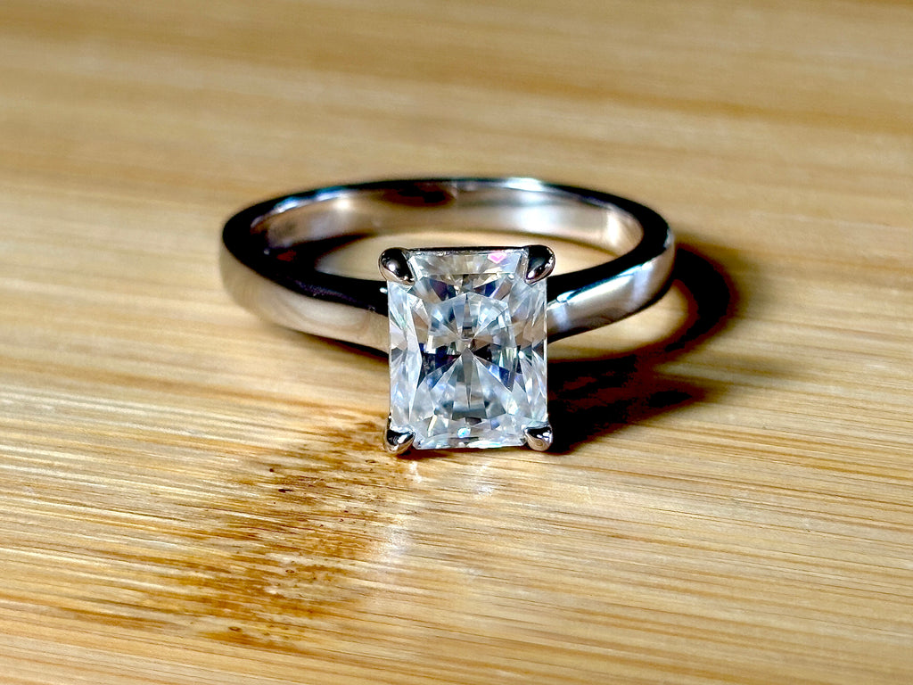 A certified Moissanite 3ct radiant solitaire! An UBER flashy, ULTRA classy, contemporary and chic radiant-cut engagement ring!