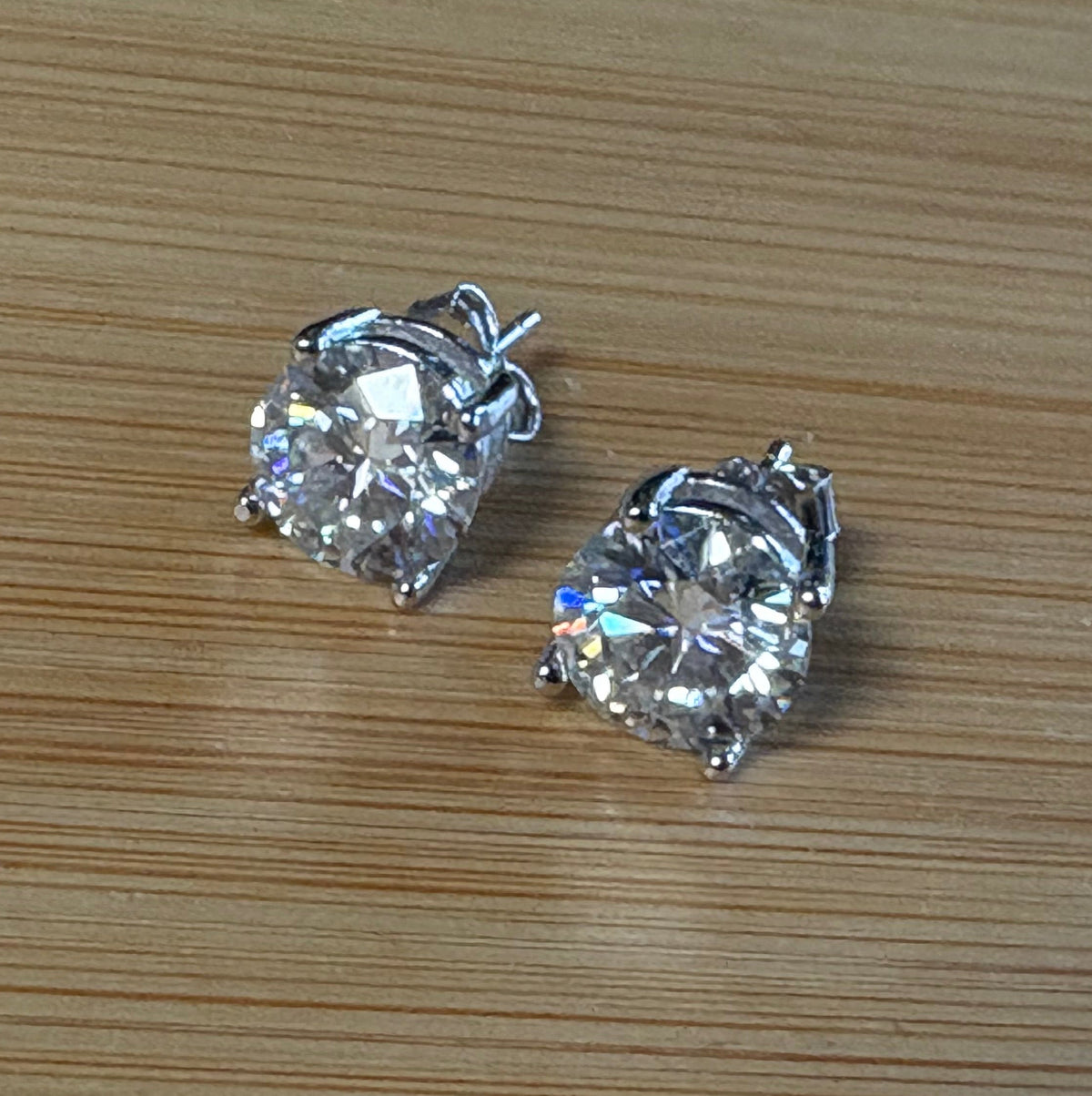 Moissanite earrings. A delicate certified 2cttw pair of 3-prong or 4-prong round brilliant Moissanites in 18k gold-embraced sterling silver baskets! Classic!