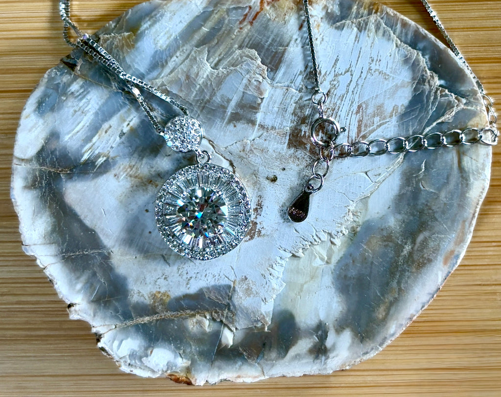 Moissanite necklace. The certified 2ct Moissanite “Sunburst” necklace with a 61 gemstone pendant plus more in the bail! Radiantly beautiful!