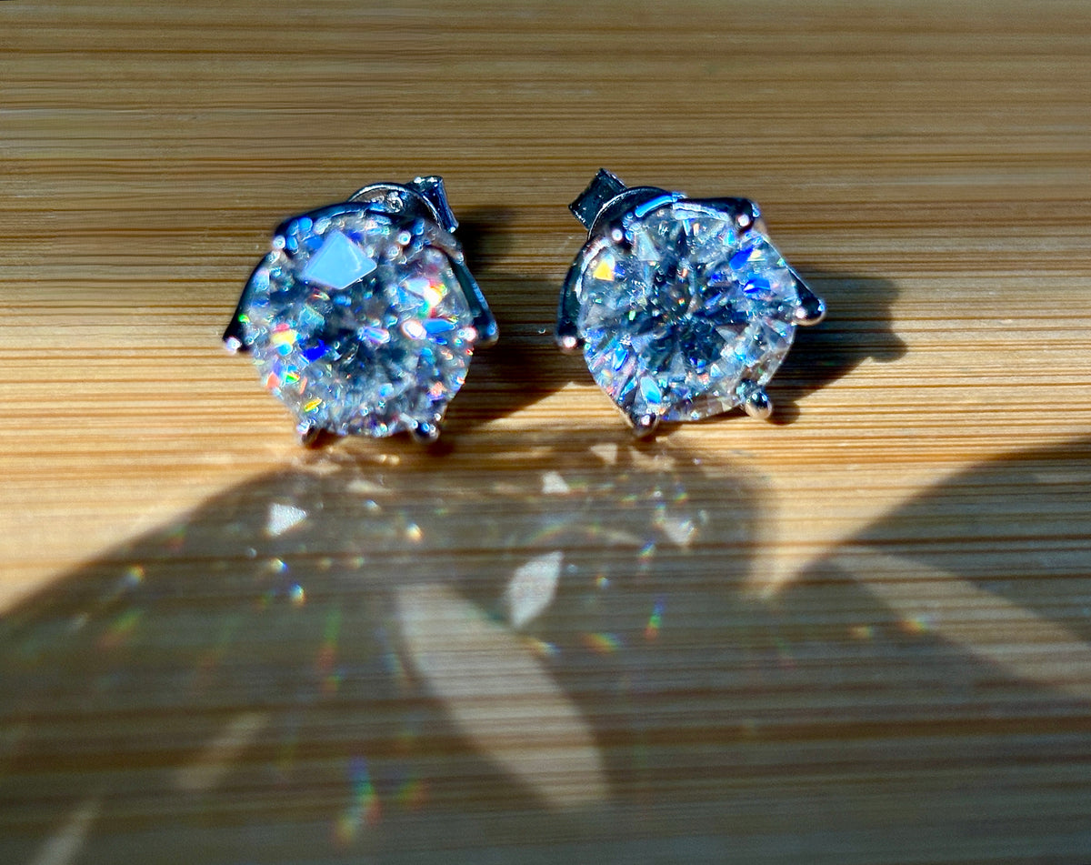 A 10ctw pair of double certified Moissanite studs in lotus-shaped sterling silver baskets!