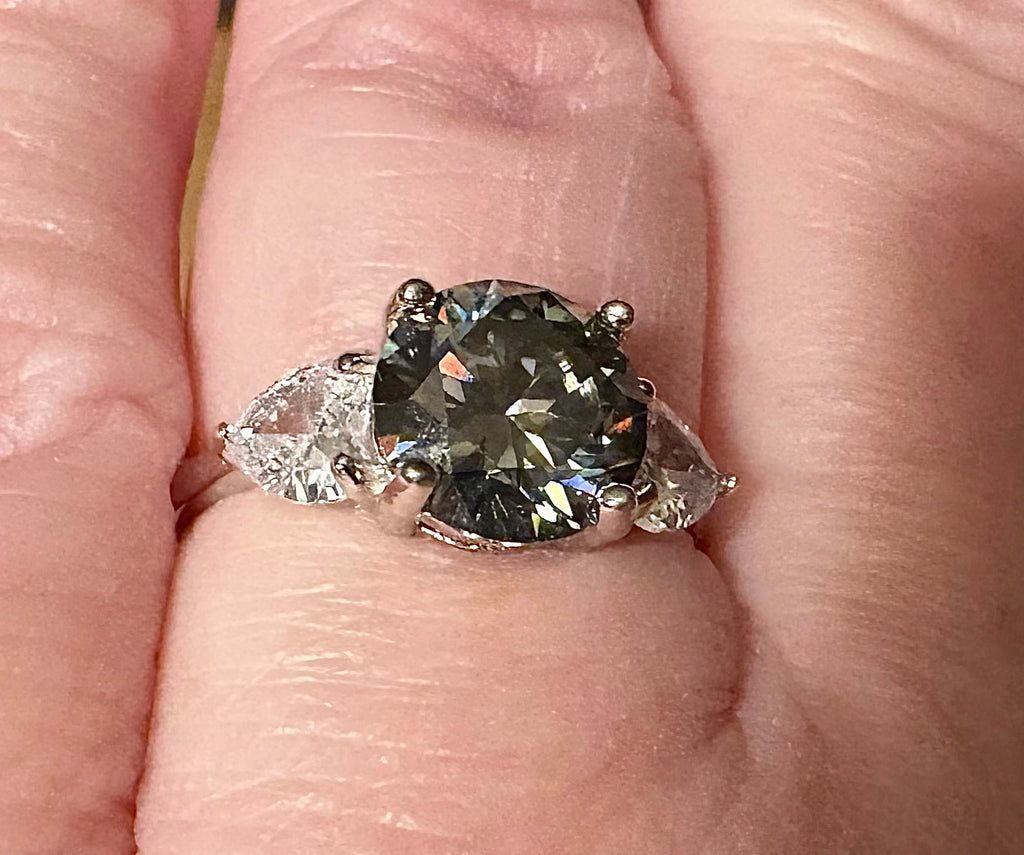 Moissanite ring. A 3ct certified GRAY Moissanite with 1.5cttw of heart-cut white zircons, set in a sterling silver basket 3-stone design!