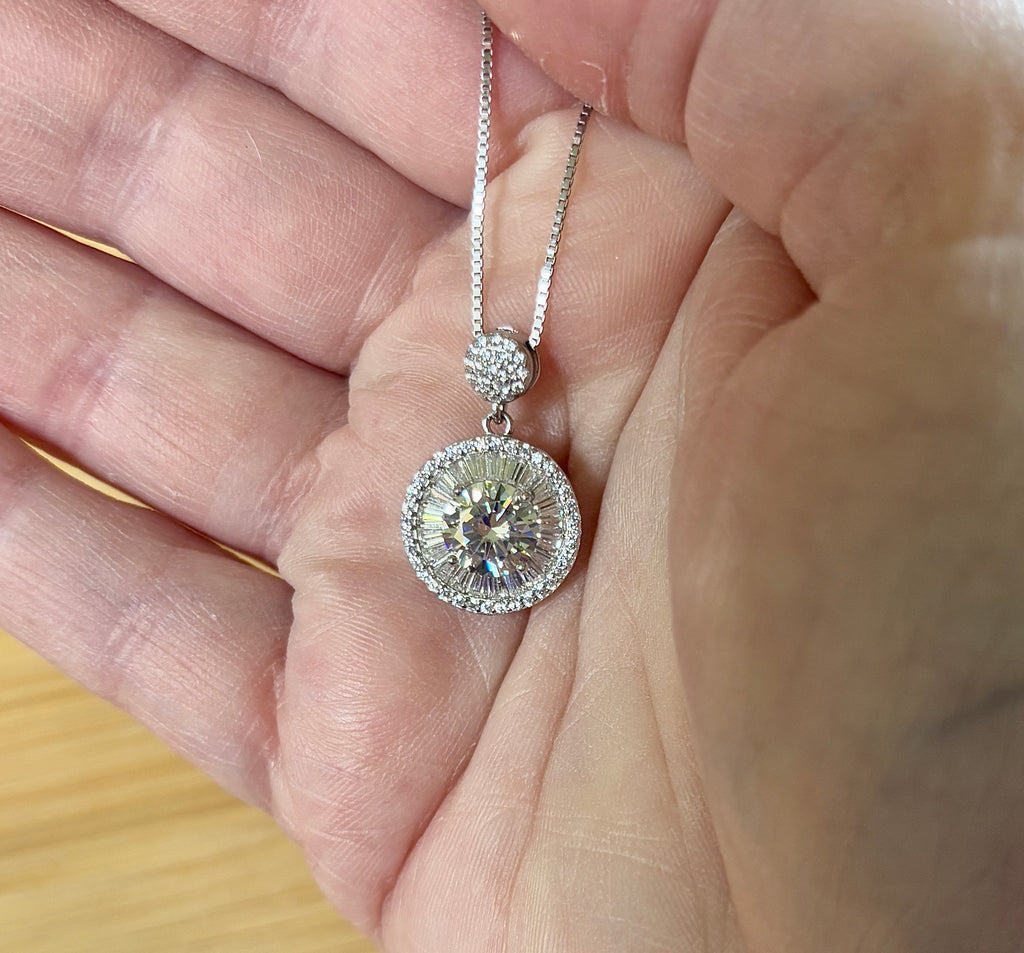 Moissanite necklace. The certified 2ct Moissanite “Sunburst” necklace with a 61 gemstone pendant plus more in the bail! Radiantly beautiful!