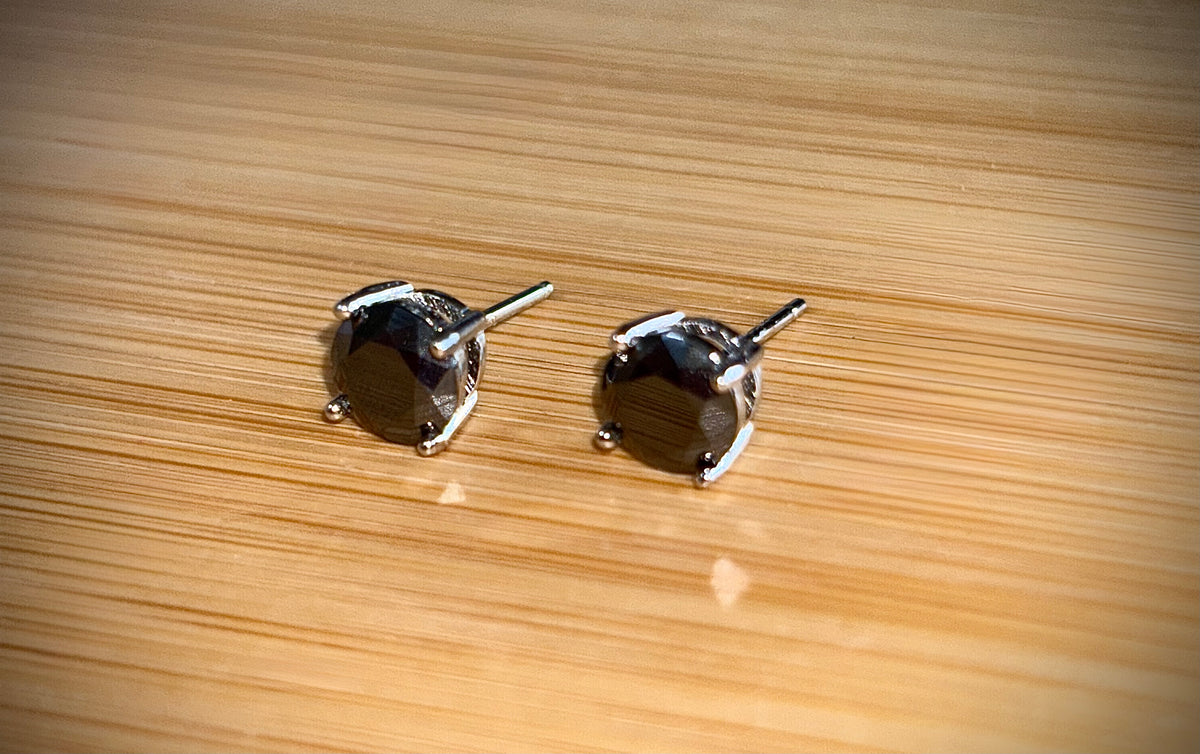 Moissanite studs. A 2cttw certified pair of black Moissanite studs in a sterling silver basket setting with 18k white gold plating!