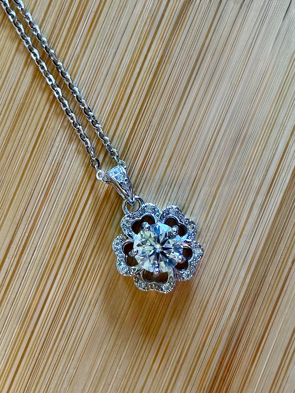 Moissanite necklace. A certified 1ct Moissanite hibiscus necklace with white zircon accents in solid sterling and white rhodium!