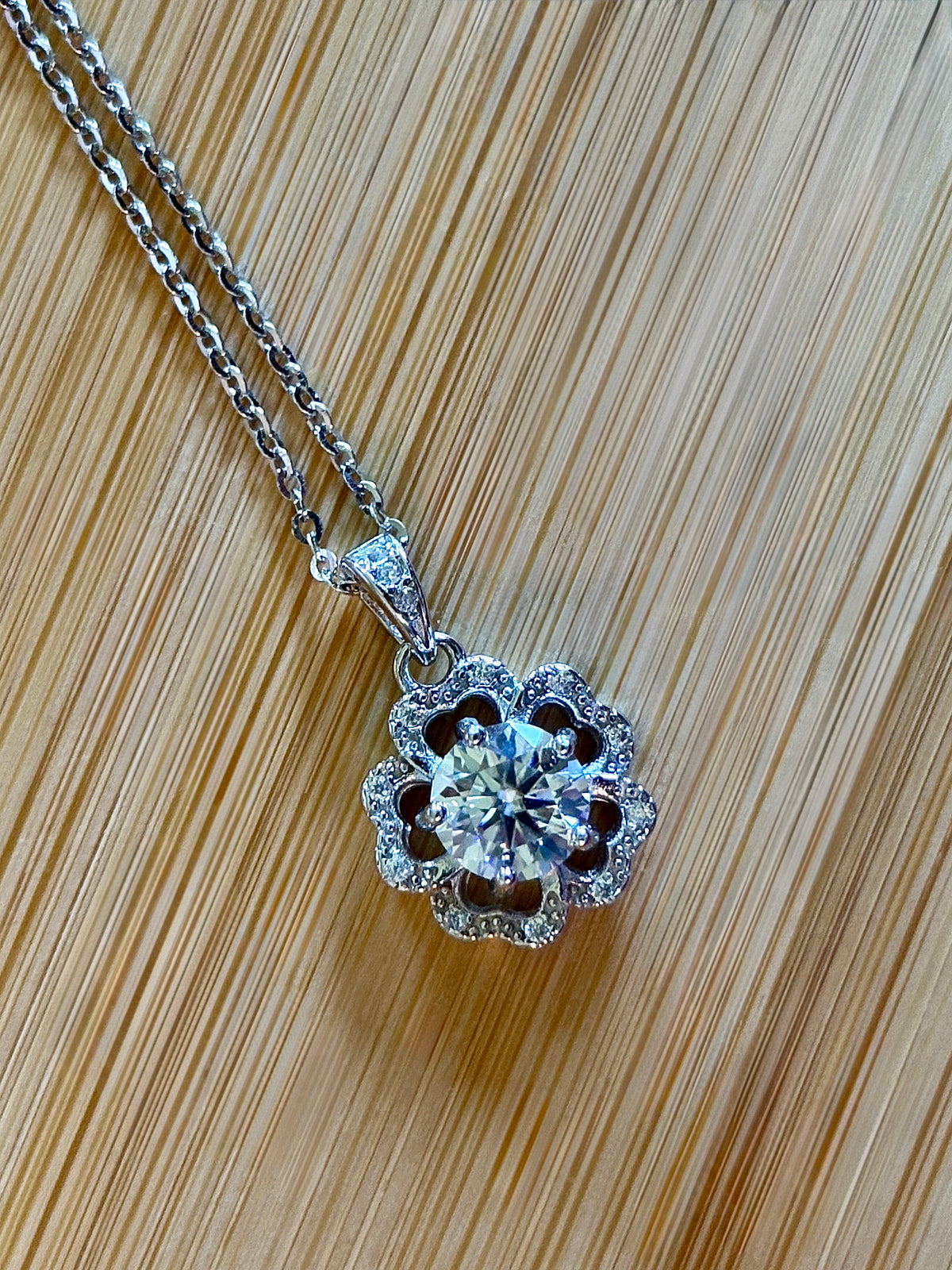 Moissanite necklace. A certified 1ct Moissanite hibiscus necklace with white zircon accents in solid sterling and white rhodium!