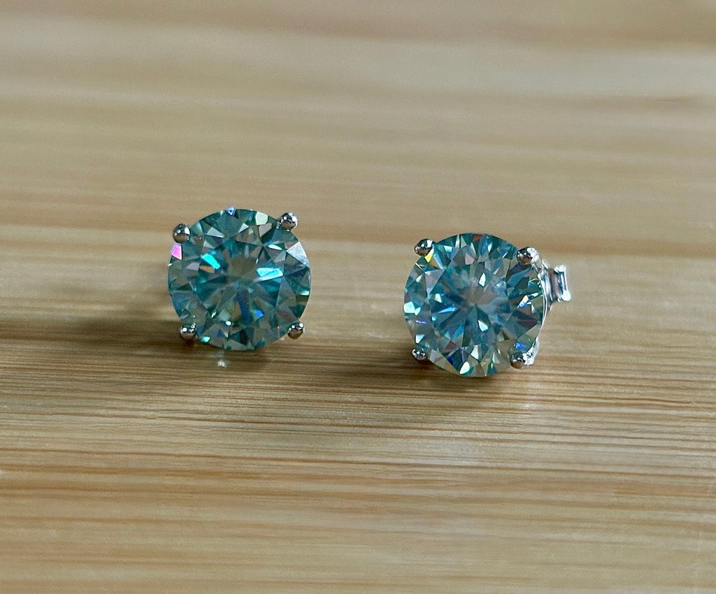 Moissanite earrings. A 6ctw certified pair of true icy baby blue Moissanite studs in sterling silver baskets with gleaming white rhodium!