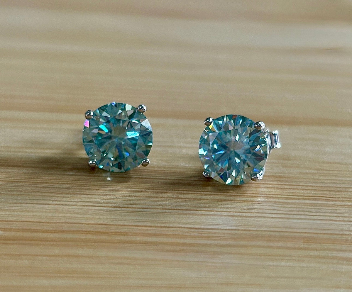 Moissanite earrings. A 6ctw certified pair of true icy baby blue Moissanite studs in sterling silver baskets with gleaming white rhodium!