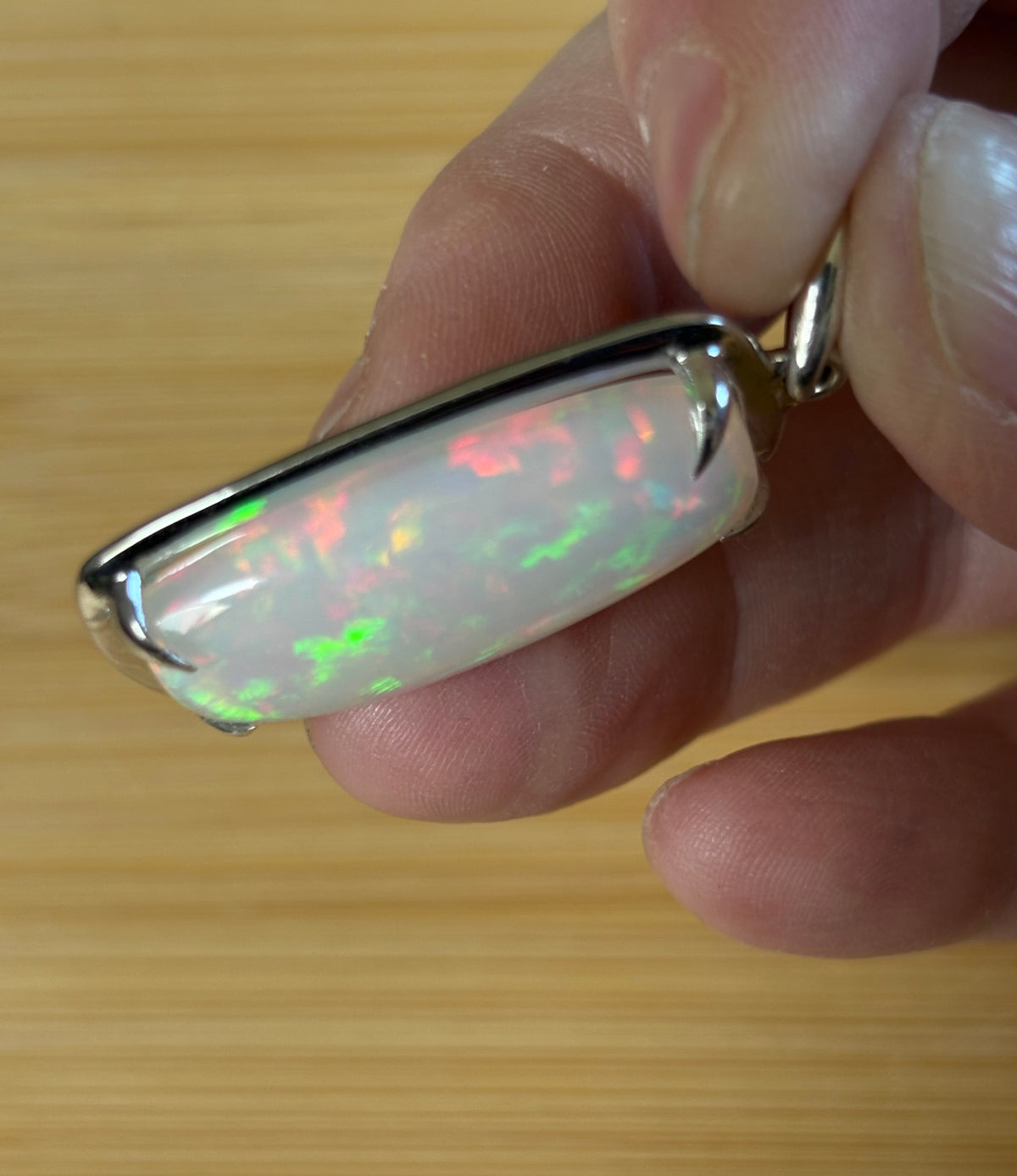 A 21ct AAA grade Ethiopian opal pendant, a handpicked opal and exclusive HKJ design! This lovely opal has gorgeous fire and play of color!