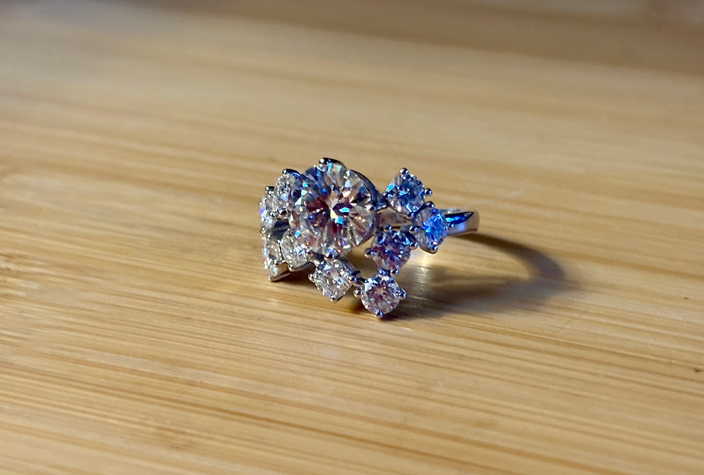 Moissanite ring. The “Moissanite Galaxy” ring features a 3ct certified Moissanite amid a 4cttw Moissanite constellation  - a 7cttw ring!
