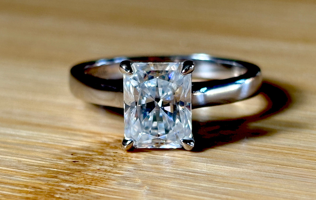 A certified Moissanite 3ct radiant solitaire! An UBER flashy, ULTRA classy, contemporary and chic radiant-cut engagement ring!