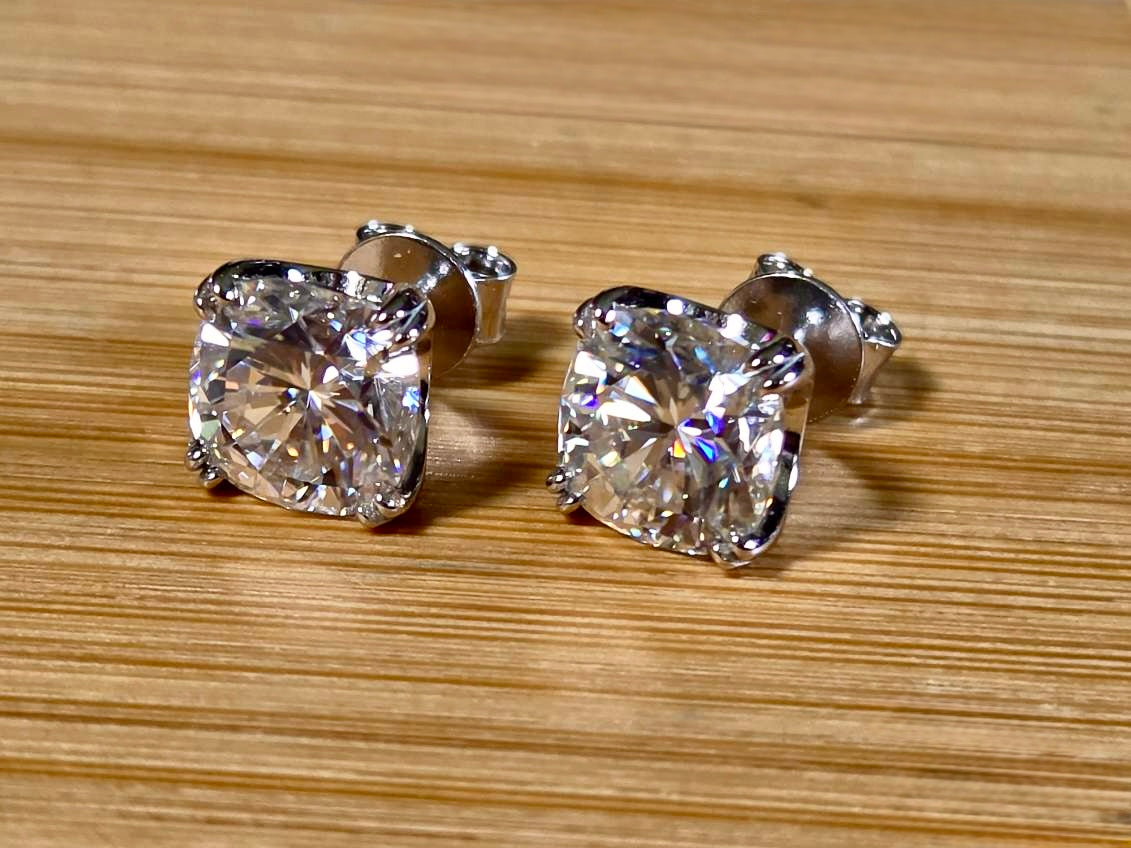6ctw cushion-cut Moissanite studs in elegant sterling silver double-claw mountings! With brilliant faceting, these earrings are showstoppers!